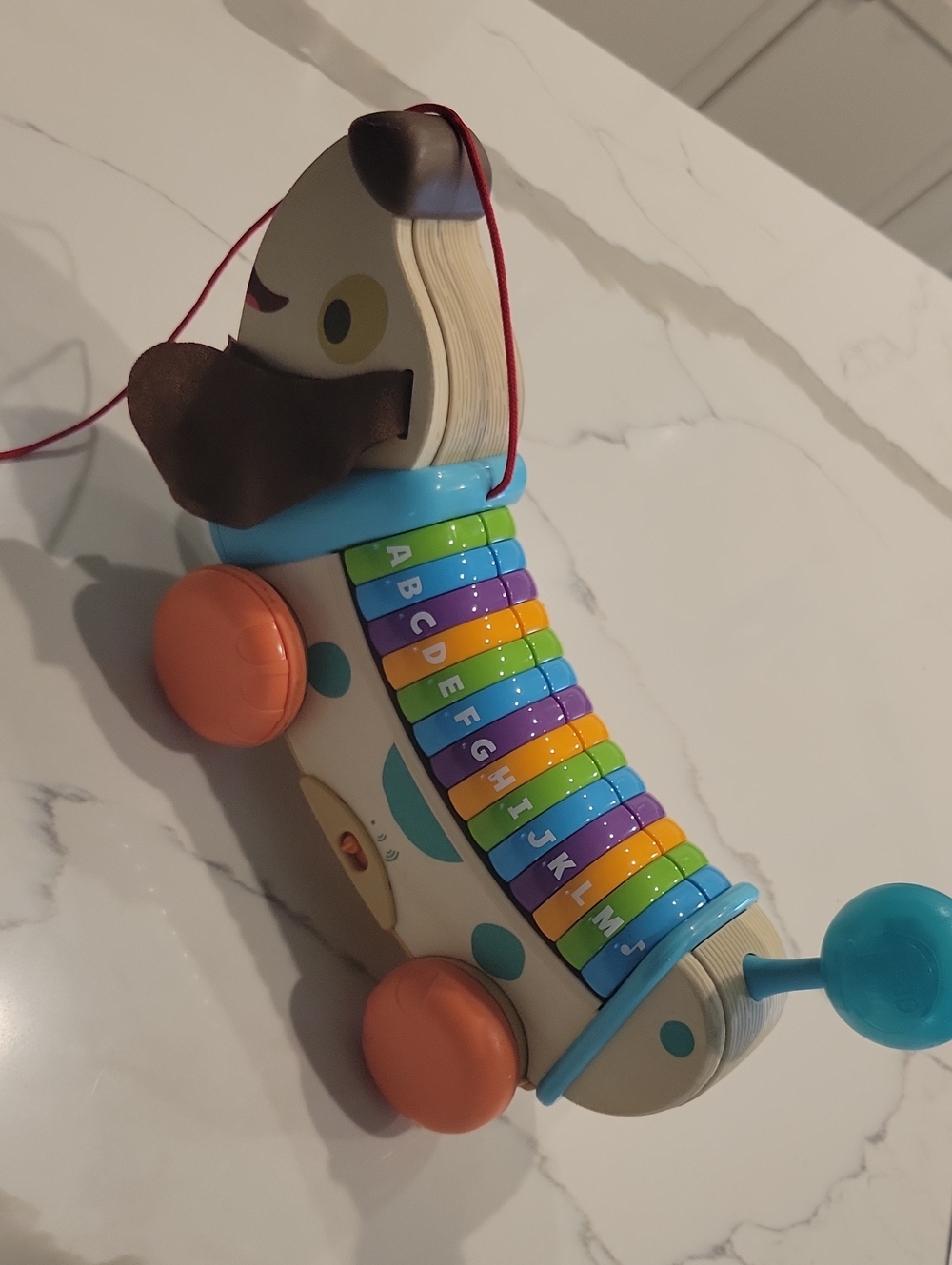 Leapfrpg Pull-Along Dog Xylophone Toy in Blue, Orange, Green